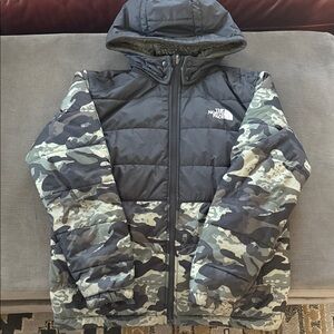 The North Face Kids Reversible Black and Army Green Camo Puffer Jacket.